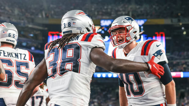New England Patriots running back Rhamondre Stevenson (38) celebrates his touchdown with quarterback Mac Jones (10) during the second half against the New York Giants at MetLife Stadium.